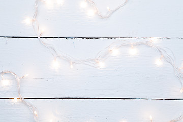 Image showing Christmas garland on wooden floor