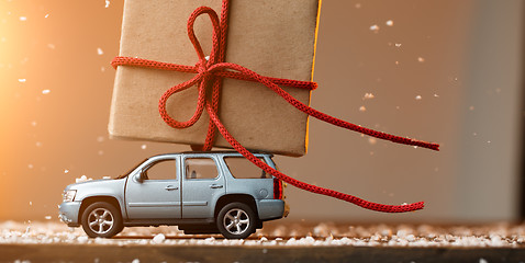 Image showing Car carrying gift background snow