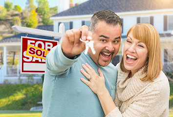 Image showing Mixed Race Couple With Keys in Front of Real Estate Sign and New