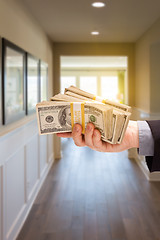 Image showing Male Hand With Stack of Cash Inside Hallway of House