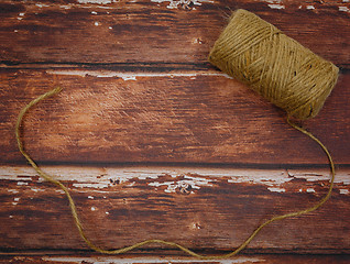 Image showing Rough thread reel on wood background