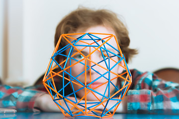 Image showing Young Man Behind The Volumetric Model Of Geometric Solid