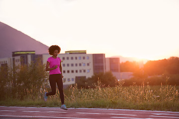 Image showing a young African American woman jogging outdoors