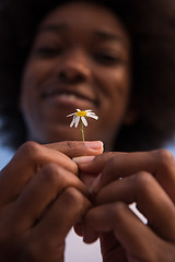 Image showing portrait of African American girl with a flower in her hand