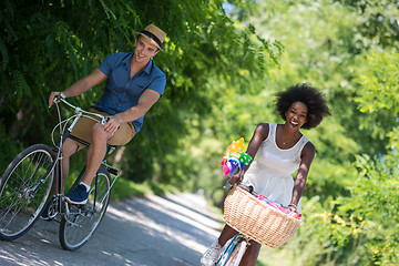 Image showing Young  couple having joyful bike ride in nature