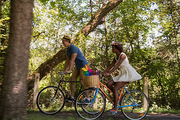 Image showing Young  couple having joyful bike ride in nature