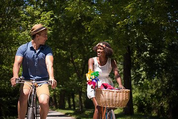 Image showing Young  couple having joyful bike ride in nature