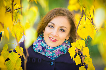 Image showing Portrait of the girl in the yellow foliage of trees