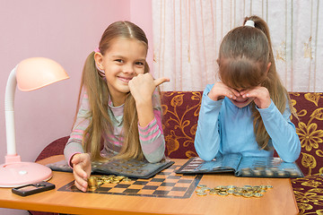 Image showing Older sister hurt her younger sister and laughing at her