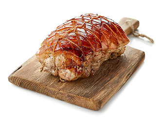 Image showing roasted pork on wooden cutting board