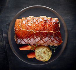 Image showing roasted pork on dark plate