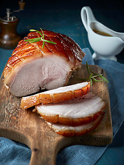 Image showing roasted pork on wooden cutting board