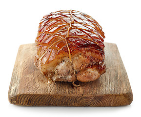 Image showing roasted pork on wooden cutting board