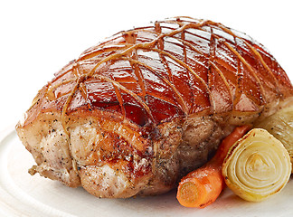 Image showing roasted pork on wooden cutting board