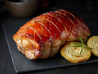 Image showing roasted pork on black stone plate