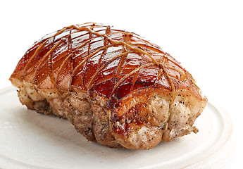 Image showing roasted pork on wooden cutting board