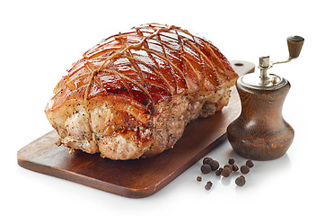 Image showing roasted pork on wooden cutting board