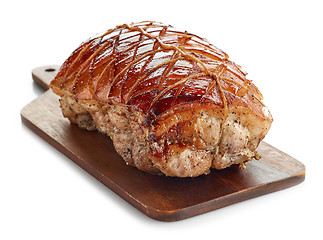 Image showing roasted pork on wooden cutting board