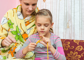 Image showing Mom shows how to learn to knit