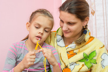 Image showing Mom teaches daughter to knit seven years