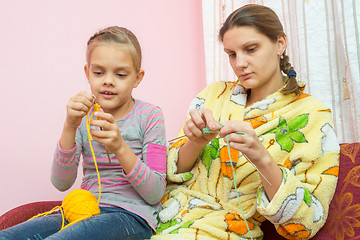 Image showing Mom and daughter seven-year-knit on the needles sitting on the couch