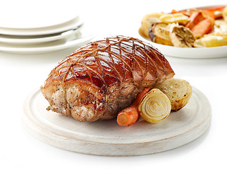 Image showing roasted pork on wooden cutting board