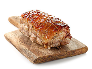 Image showing roasted pork on wooden cutting board