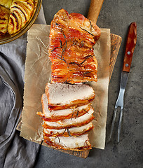 Image showing roasted pork on wooden cutting board