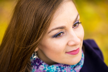 Image showing Rub the beautiful girl close up on blurred background of autumn leaves