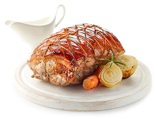 Image showing roasted pork on wooden cutting board