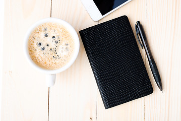 Image showing Smartphone with notebook and cup of strong coffee