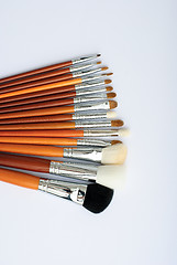 Image showing makeup brush and cosmetics, on a white background