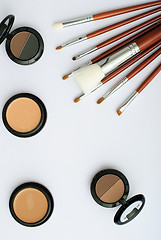 Image showing makeup brush and cosmetics, on a white background