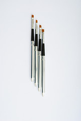 Image showing makeup brush and cosmetics, on a white background