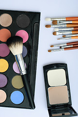 Image showing makeup brush and cosmetics, on a white background