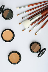 Image showing makeup brush and cosmetics, on a white background