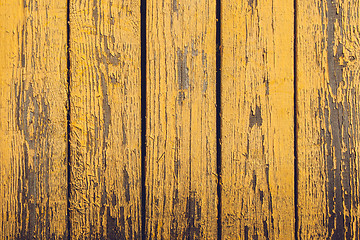 Image showing Yellow wooden planks with peeling paint