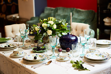 Image showing Beautifully decorated table set with flowers, candles, plates and serviettes for wedding or another event in the restaurant.