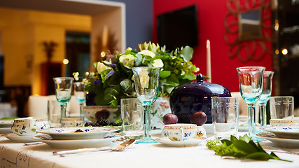 Image showing Beautifully decorated table set with flowers, candles, plates and serviettes for wedding or another event in the restaurant.