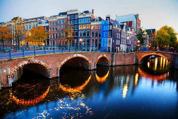 Image showing Amsterdam city view with canals and bridges