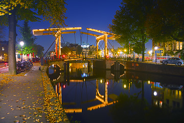 Image showing Amsterdam city view with canals and bridges