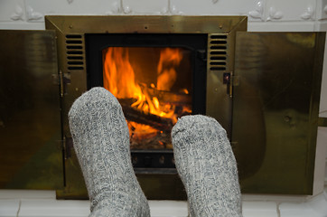 Image showing Feet in front of fireplace