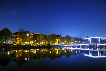 Image showing Amsterdam city view with canals and bridges