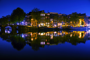 Image showing Amsterdam city view with canals and bridges