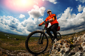 Image showing Young man is riding bicycle outside. Healthy Lifestyle.