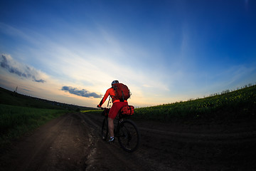 Image showing Young man is riding bicycle outside. Healthy Lifestyle.