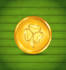 Image showing Golden coin with clover on green wooden texture for St. Patrick\'