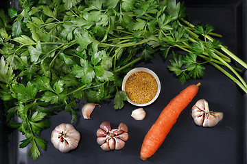 Image showing Parsley leaves and vegetables on a dark tray.