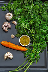 Image showing Parsley leaves and vegetables on a dark tray.
