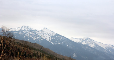 Image showing Mountain ridges covered with snow and overcast sky.